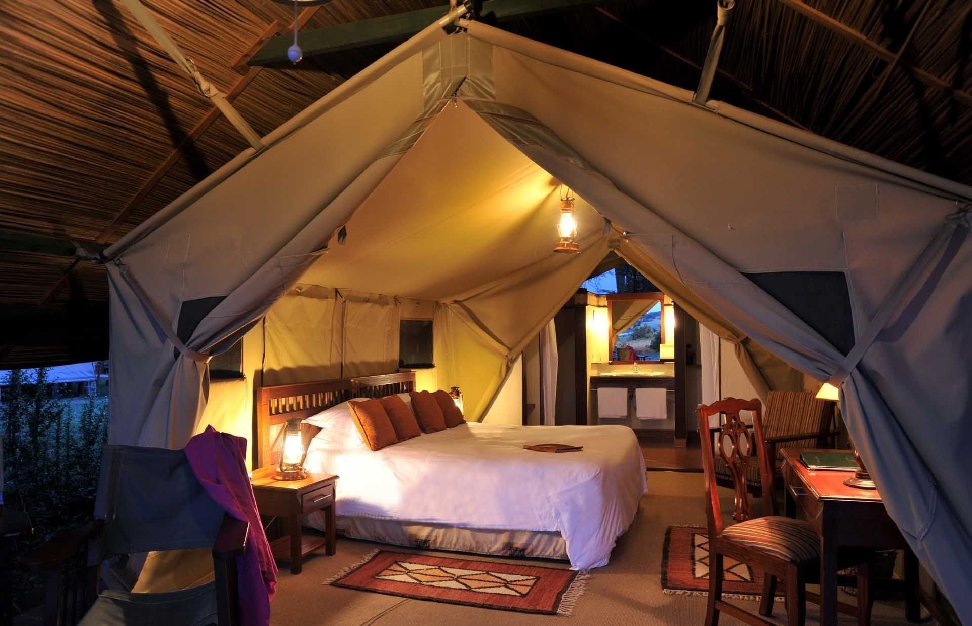 Sweetwaters Tented Camp — tent interior at dusk
