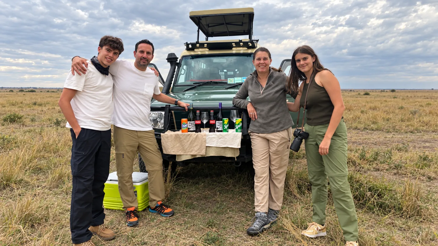 A family in an open safari vehicle watching wildlife