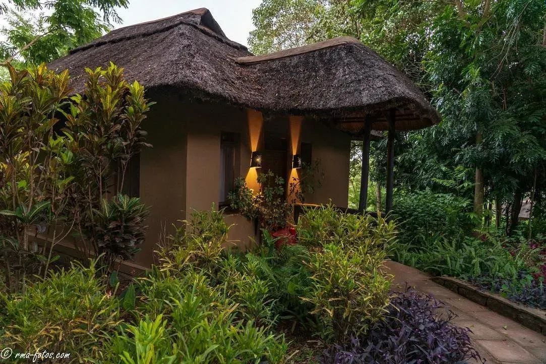 Kitela Lodge — thatched cottage at night