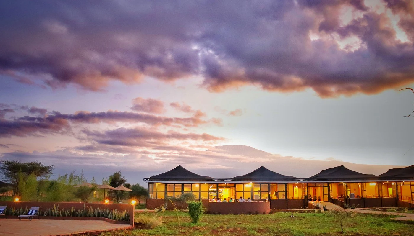 Praro Amboseli Camp — camp at dusk beneath Kilimanjaro