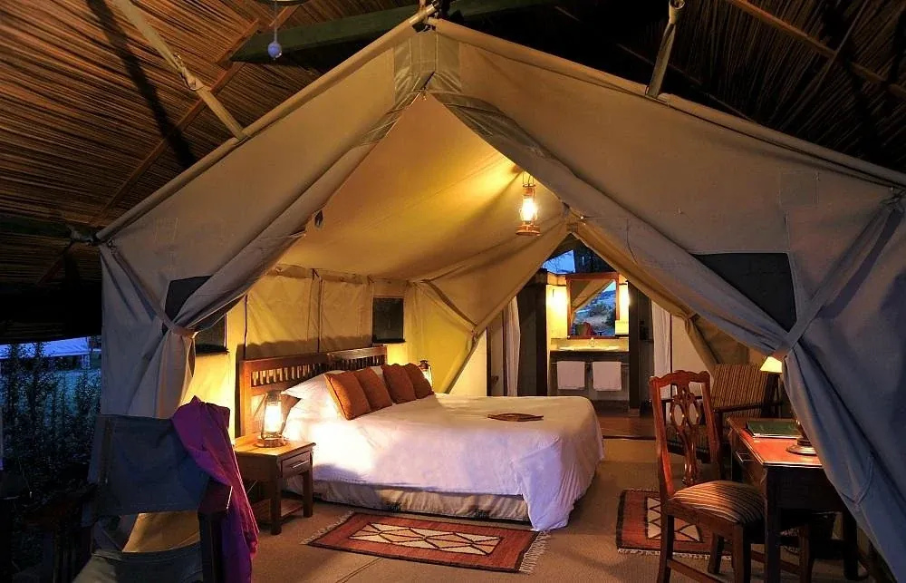 Sweetwaters Tented Camp — candlelit tent at dusk